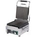 A Waring Panini Perfetto commercial grill with a grooved top and bottom.
