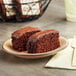 A Ne-Mo's Bakery individually wrapped chocolate cake square on a plate.