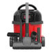 A red and black NaceCare Solutions cordless canister vacuum with a brush attachment.