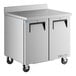 A stainless steel True worktop refrigerator on a counter.