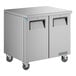 A stainless steel True undercounter refrigerator with black handles.