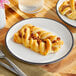 A plate with a vegan maple pecan braided danish on a table.