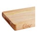 A wooden Choice cutting board with rounded edges.