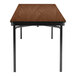 A brown rectangular National Public Seating Montana Walnut folding table with a black frame.