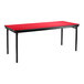 A red National Public Seating folding table with black legs and a black T-mold edge.