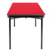 A red rectangular National Public Seating folding table with black legs.