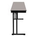 A gray National Public Seating folding table with a black edge and black cantilever legs.