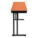 A National Public Seating Max table with a Wild Cherry wood surface and black T-mold edge.