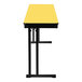 A yellow National Public Seating folding table with black legs and a woodgrain top.