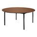 A National Public Seating round table with black legs and a brown wood surface.