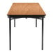 A National Public Seating Bannister Oak plywood folding table with black legs and a T-mold edge.