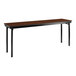 A National Public Seating Montana Walnut rectangular folding table with black legs.