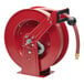 A red Reelcraft hose reel with a hose attached.