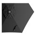 A black umbrella for a round table with a black handle on a white background.