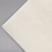 A close-up of a Hoffmaster ivory paper napkin.