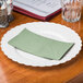 A Soft Sage Green Hoffmaster paper napkin on a white plate.