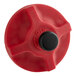 A close-up of a red plastic knob with a black valve button.