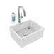 A white Zurn farmhouse sink with a silver filtered faucet above it and a soap bottle.