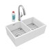 A Zurn white fireclay double bowl farmhouse sink with a silver faucet and soap dispenser.