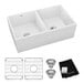 A Zurn Elkay white fireclay double bowl farmhouse sink with two drain holes.