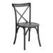 A Lancaster Table & Seating Vineyard Series Smokey Black Outdoor Cross Back Chair with a wooden seat and a cross back.