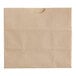 A natural brown Bagcraft paper bag with a hole in it.