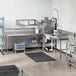 A stainless steel Regency dishtable with a sink in a school kitchen.