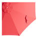 A close-up of a red Lancaster Table & Seating umbrella with a curved edge.