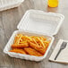 A white Choice take out container with chicken strips and french fries.