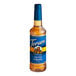A close up of a Torani Sugar-Free Salted Caramel Flavoring Syrup 750 mL plastic bottle with a blue label.