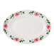 An eggshell white Tuxton China oval platter with pink flowers on it.
