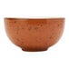 A coral Tuxton soup bowl with brown specks.