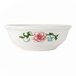 A white Tuxton china bowl with a flower design.