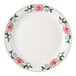 A white Tuxton China plate with pink flowers and a narrow rim.