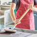 A person using a Choice stainless steel bristle grill brush to clean a grill.