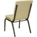 A beige church chair with a cushion and a gold vein metal frame.