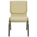 A beige Flash Furniture church chair with a gold vein metal frame.