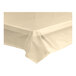 A close-up of a ivory plastic Table Mate table cover on a white surface.