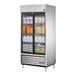 A True 2 section sliding glass door refrigerator full of dairy products and eggs.