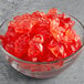 A bowl of Vidal pink flamingo gummies on a table.