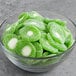 A bowl of Vidal Sour Gummy Kiwis on a table.