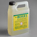 A white plastic jug of Mrs. Meyer's Clean Day honeysuckle hand soap with a yellow label.