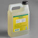 A white plastic jug of yellow Mrs. Meyer's Honeysuckle scented hand soap refill.