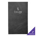 A black customizable leather menu cover with a logo on a table.