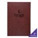 A red leather menu cover with black text on a table.
