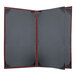 A grey rectangular menu cover with a red border and black leather.