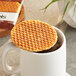 A Vafels vegan stroopwafel on a cup of coffee.