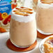 Two glasses of vanilla almond milk with a pastry.