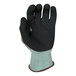 A close-up of an Armor Guys Kyorene Pro heavy duty work glove with black and green HCT microfoam nitrile coating and a blue cuff.