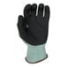 A close-up of an Armor Guys gray and blue work glove with black and green coating.